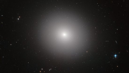 An elliptical galaxy, which looks like an elliptical cloud of fine dust