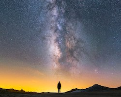 Woman's silhouette with the milky way in front of her