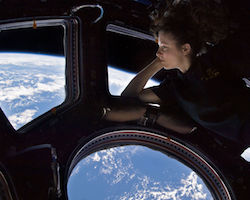Trace Caldwell in the International Space Station, looking out on Earth