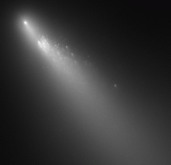 A gif of a comet that is breaking up into smaller pieces.