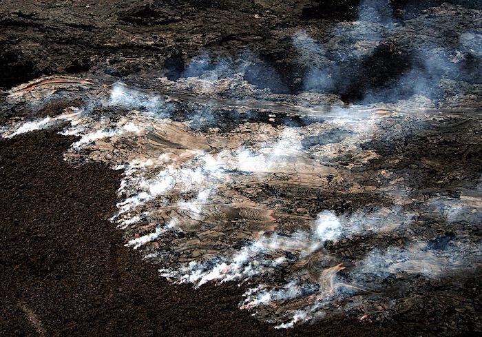 Lava flowing across an old lava field, burning moss that had grown on the old lava